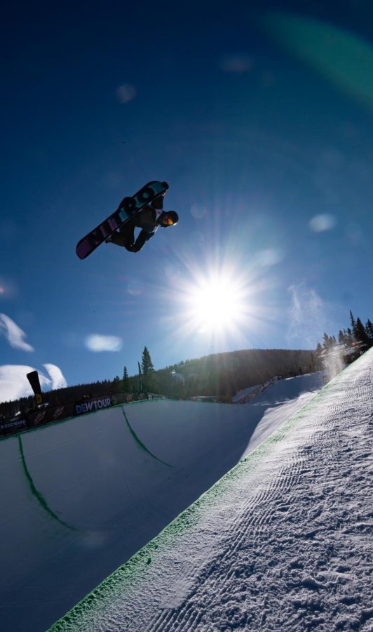 Jan Scherrer grabs the nose of his board during one of his superpipe finals runs at Dew Tour