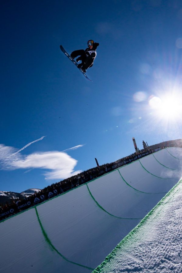 Valentino Guseli grabs his board during one of his runs in men's superpipe finals at Dew Tour