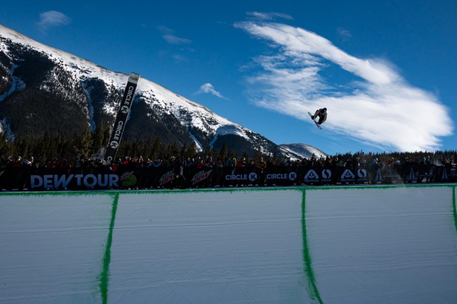 Andre Hoeflich grabs his board above the crowd during men's superpipe finals at Dew Tour