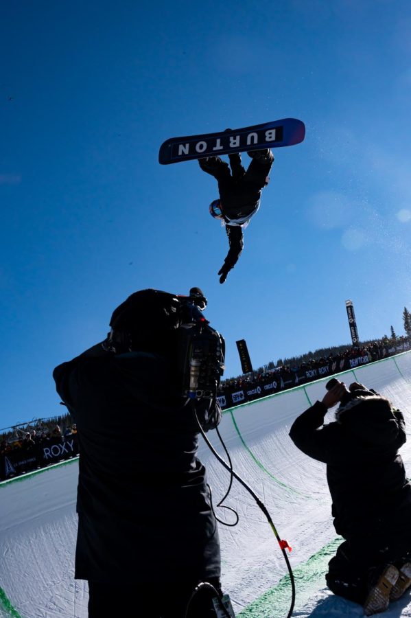 Valentino Guseli grabs his board and flips over the camera crew during men’s superpipe finals at Dew Tour