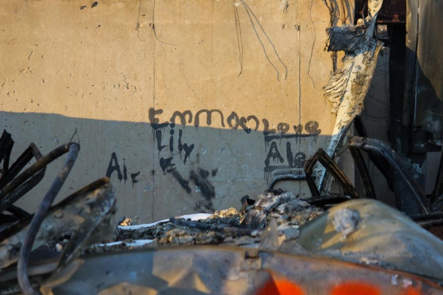 Graffiti is written on the wall of what used to be the basement.