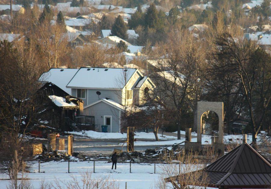 A home owner can be seen looking at the remains of his home.