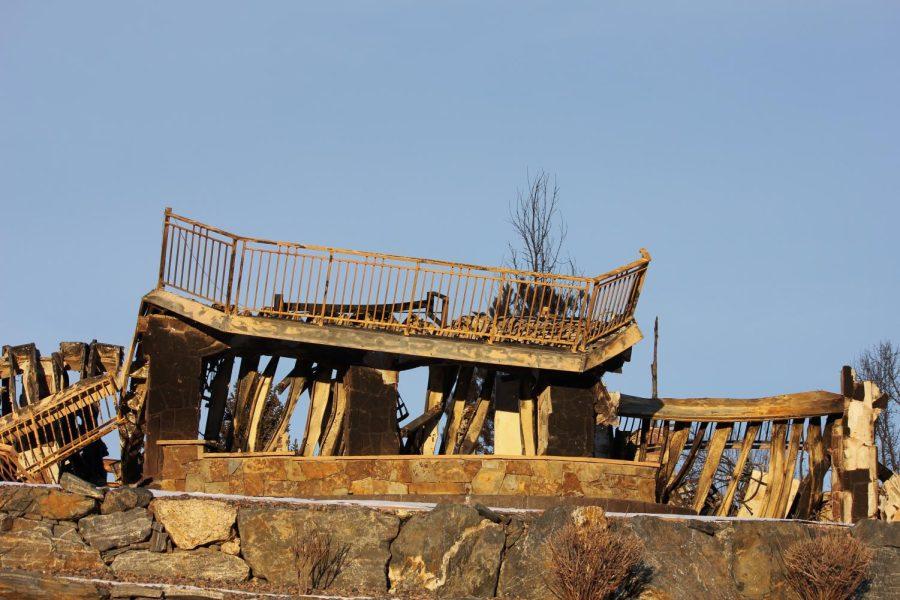 The deck of a home is destroyed and melted from the fire.