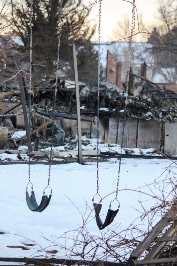 Only a melted swing remains of a former home.
