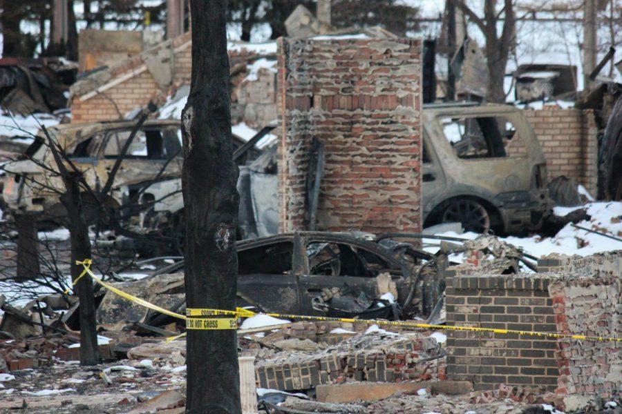 Caution tape blocks of a home that has been burnt to the ground.