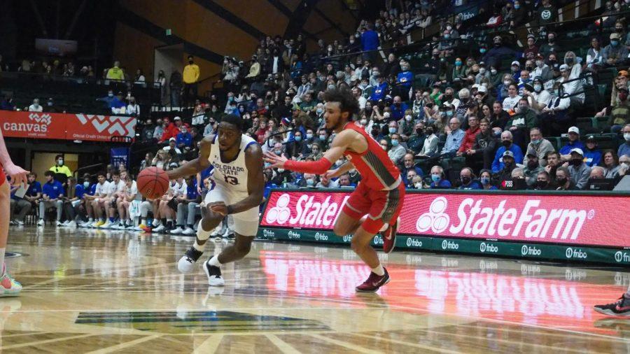 Colorado state guard Chandler Jacobs dribbles the ball into the lane as a University of New Mexico defender pursues Jan. 19. Jacobs had 12 points and the Rams won 80-74 against the Lobos 