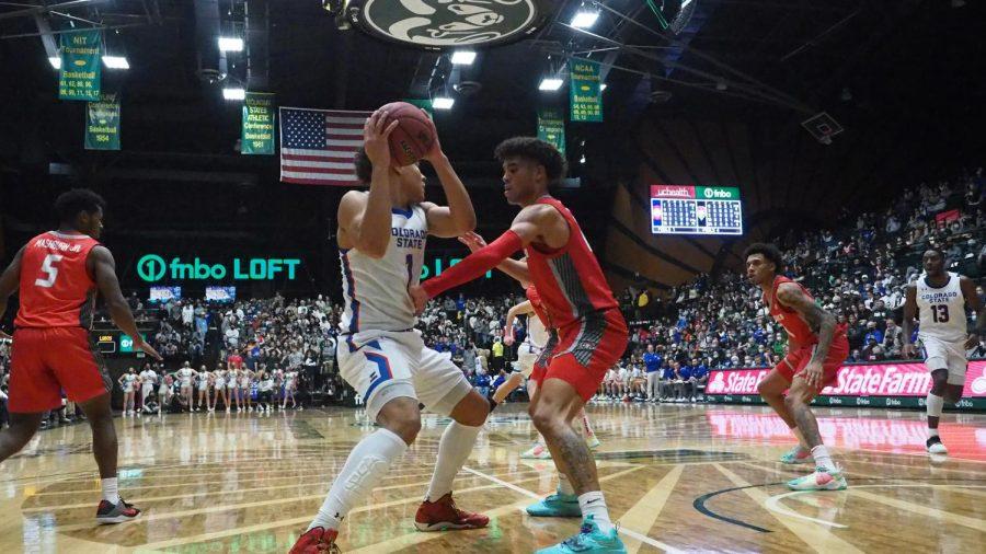 Colorado State forward John Tonje looks to pass the ball as a University of New Mexico defender attempts to trap him Jan. 19.