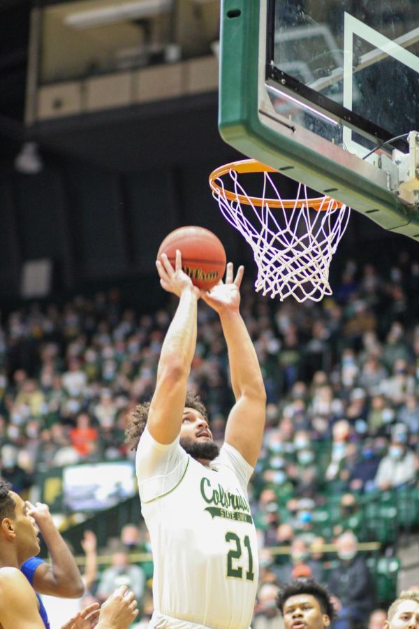 David Roddy (21), guard, jumps to dunk the ball.