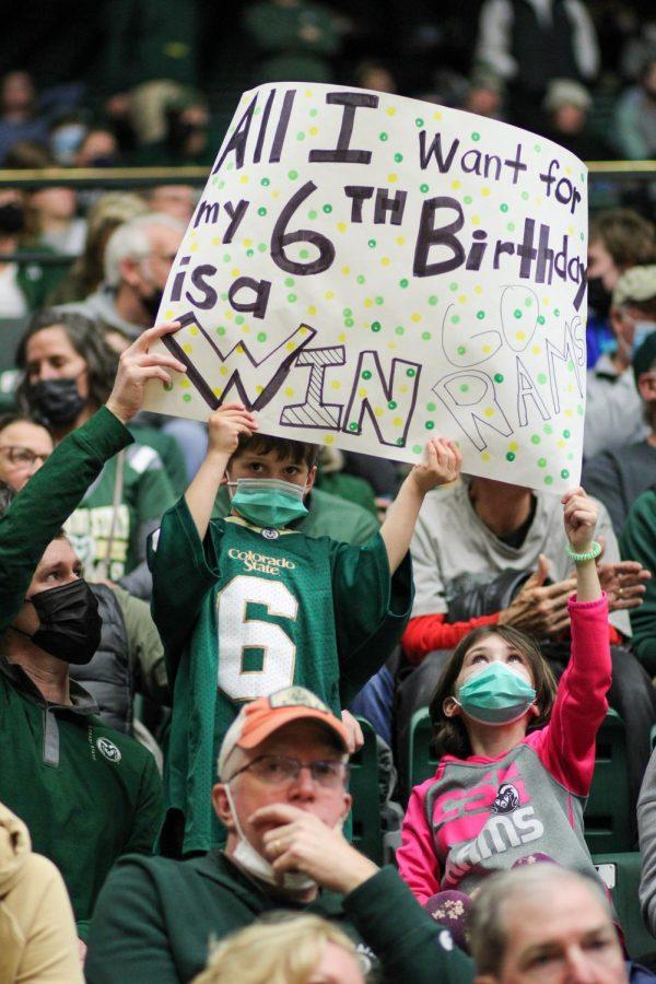 A young ram fan holds up a sign which reads, "All I want for my 6th birthday is a win. Go Rams!"