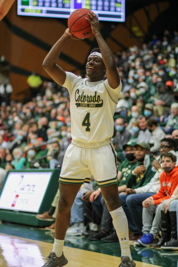 Isaiah Stevens (4), guard, smiles as he shoots a three pointer.