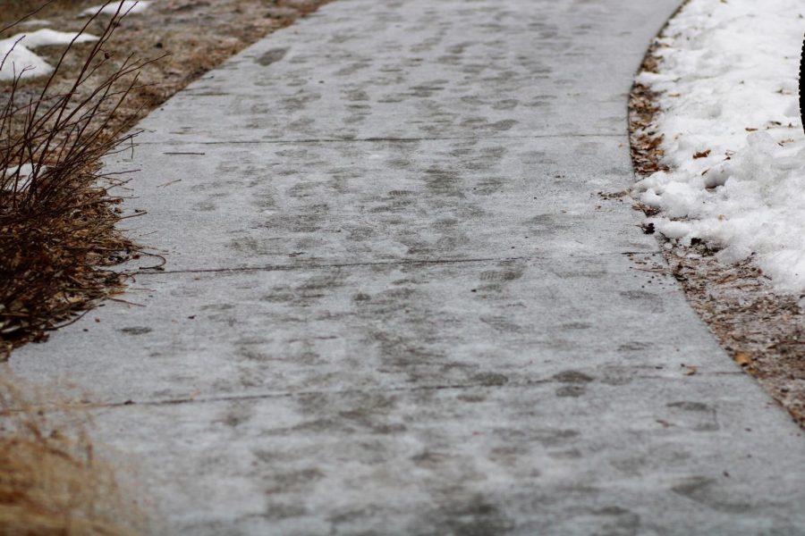 Students footprints line the snow covered sidewalks outside of Newsom Hall.