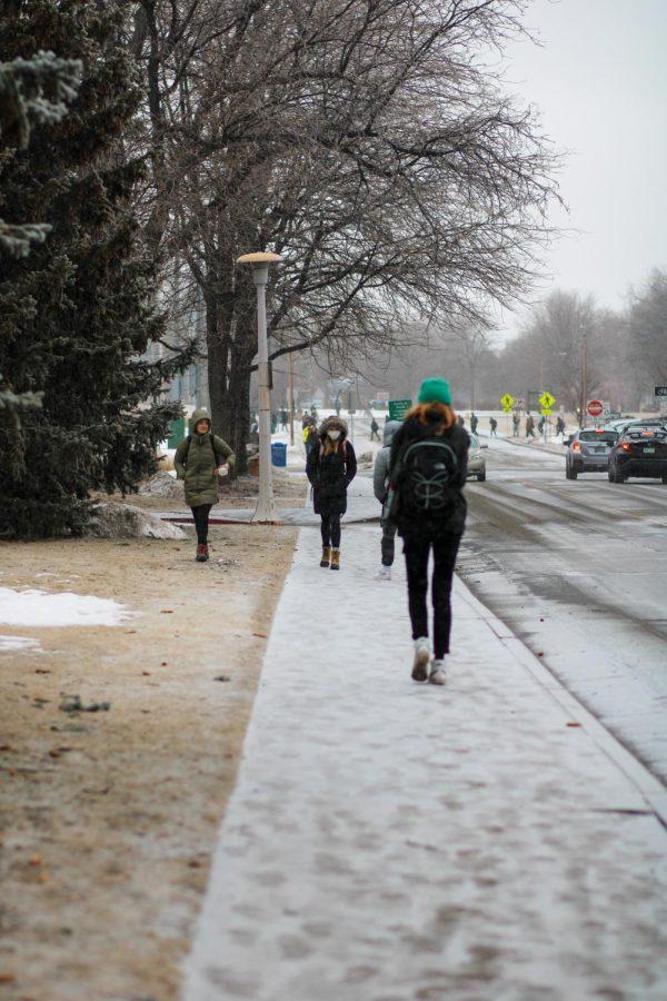 CSU students shuffle across the snow covered sidewalks on their way home.