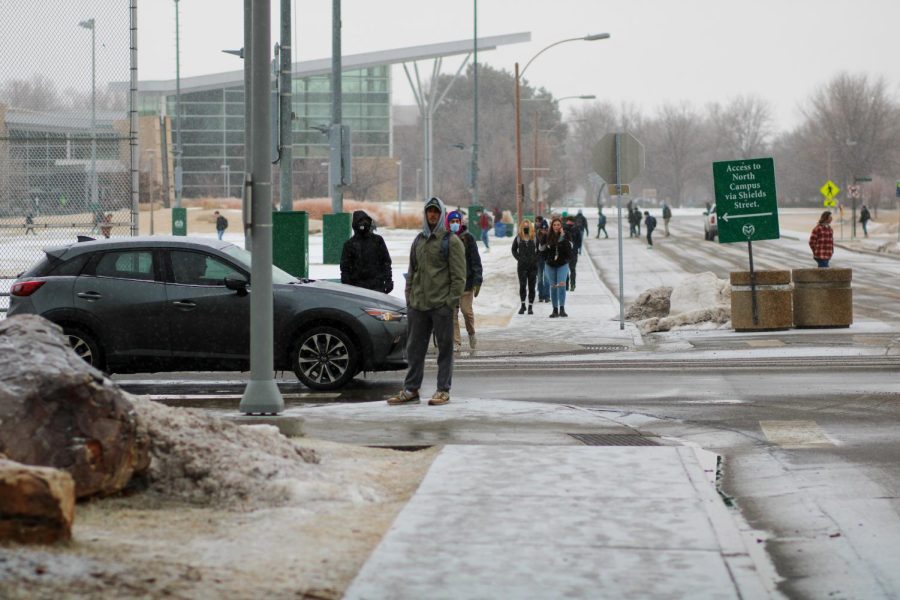 A student stands on the corner of Hughes Way and Meridian Ave. waiting for a ride Jan. 19. Many students transportation plans were uprooted when CSU made the call to cancel all classes immediately to protect students and staff from worsening weather conditions.