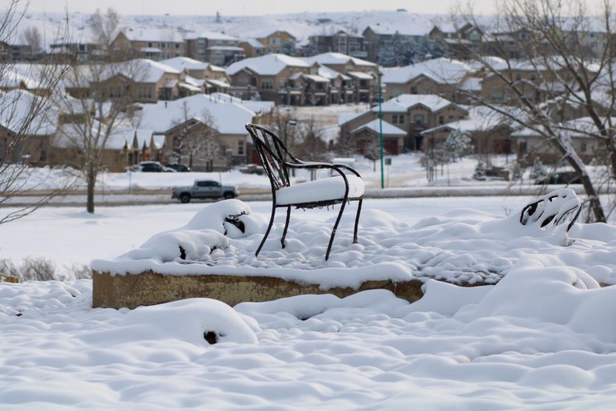 A chair, the last item standing in this home, sits on what used to be a porch.