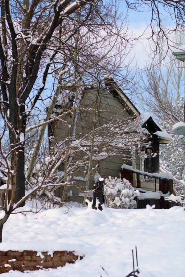 The last wall standing of a house in the Rock Creek neighborhood looks almost usrreal underneath a blanket of snow.