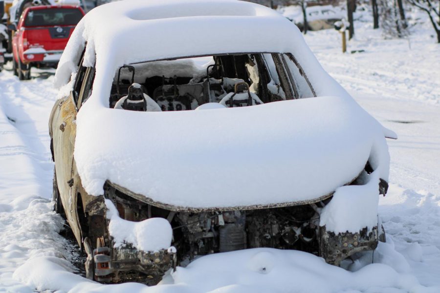 The remaints of a car sit on the side of a street in the Rock Creek residential area.