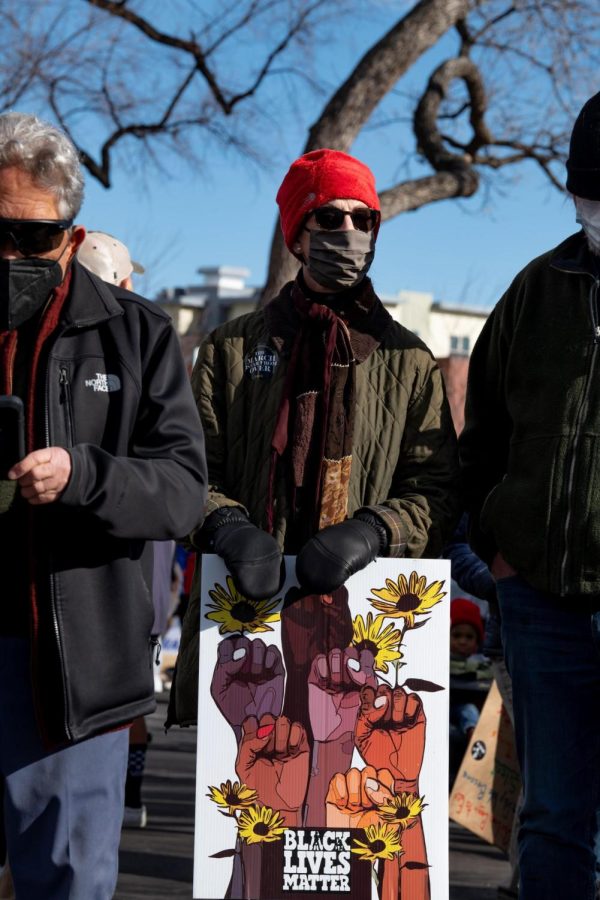 Carol Thomas holds a sign reading “Black Lives Matter” at the Martin Luther King Day Celebration in Fort Collins Colorado Jan. 17 Thaomas stated, “I'm out here today to really protest what is going on with voting rights and all of the bill being introduced to suppress voting rights.”