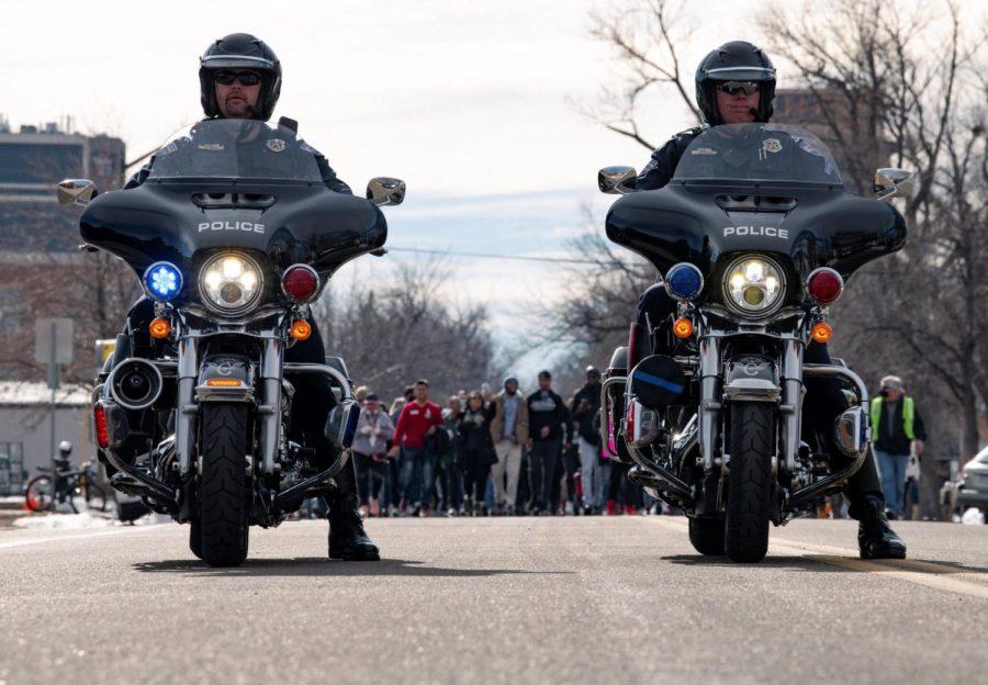 Officer Matt Brede and officer Shane Hasebroock provide escort for the Martin Luther King day march down Howes Street in Fort Collins Colorado Jan.17.