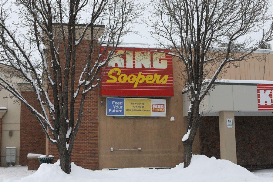 the storefront of a King Soopers surrounded by snowy trees