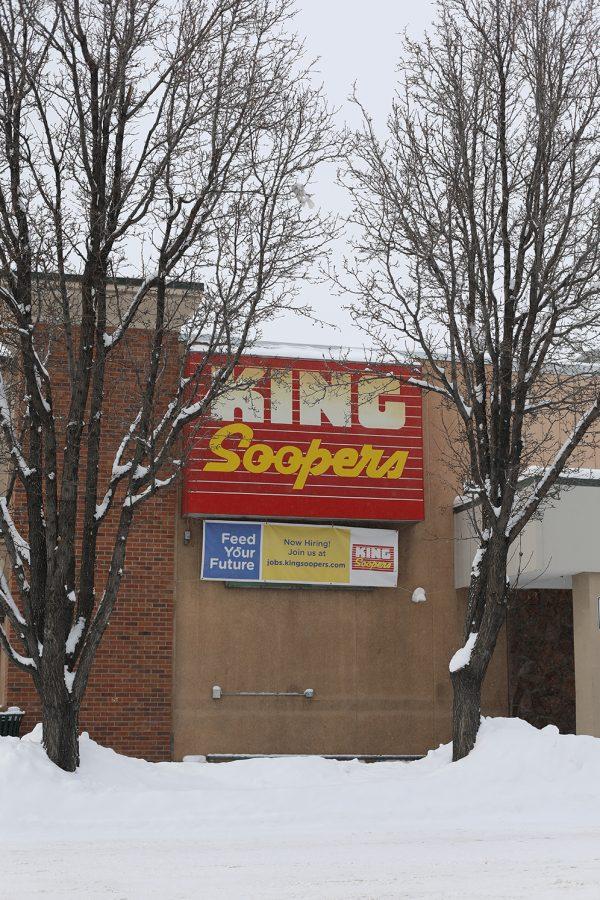 the storefront of a king soopers surrounded by snowy trees