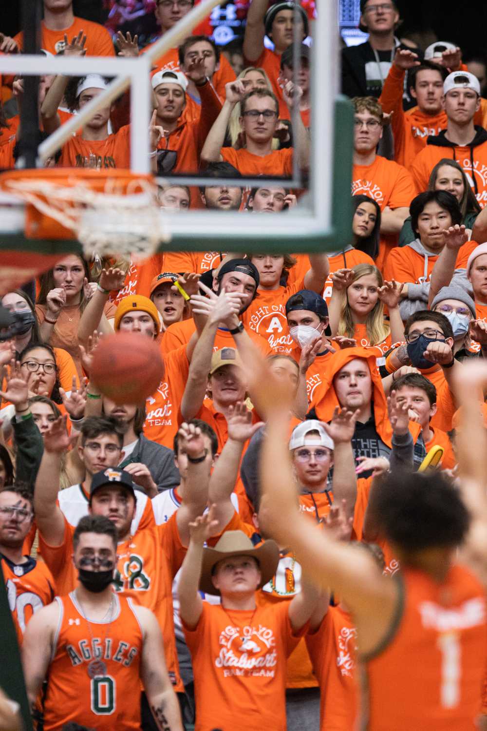 Fans hold their hands up while John Tonje (1) shoots a free throw.