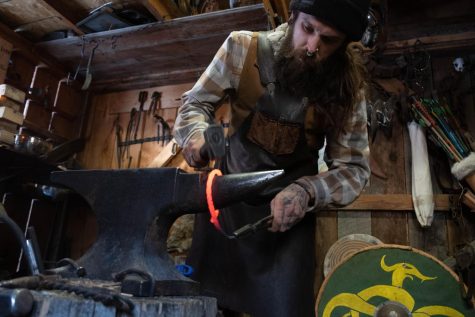 Blacksmith Raven Hammer bends a twisted rod to create the Norse world snake Feb.8