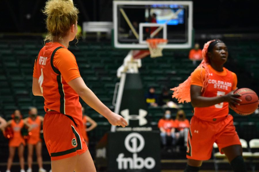 Mckenna Hofschild (4) and Upe Atosu Colorado State University basketball players on the court during an orange out game against the Utah State Aggies.