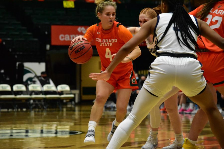 Mckenna Hofschild (4) playing an aggressive offense with the ball during a game against the Utah State Aggies.