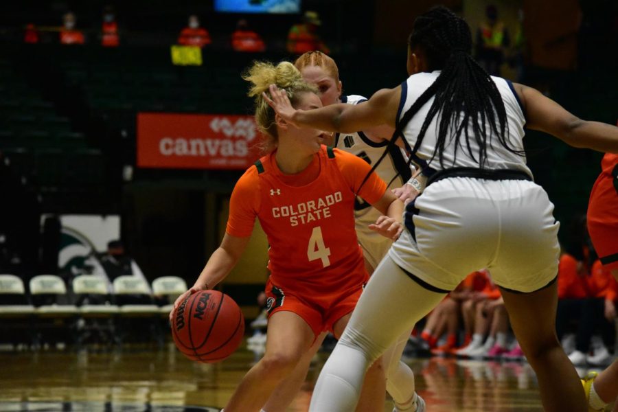 Mckenna Hofschild (4) playing an aggressive offense with the ball during a game against the Utah State Aggies.