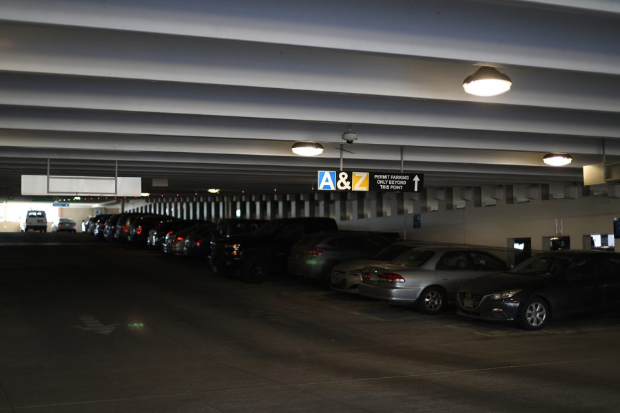 Cars are parked up an incline in a parking garage