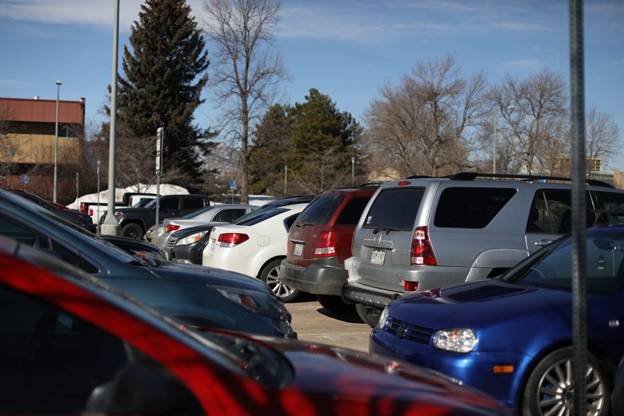 Cars fill a parking lot on a sunny day