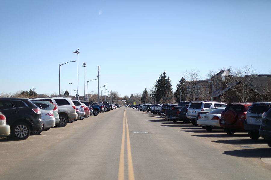 Cars are parked diagonally on each side of a street