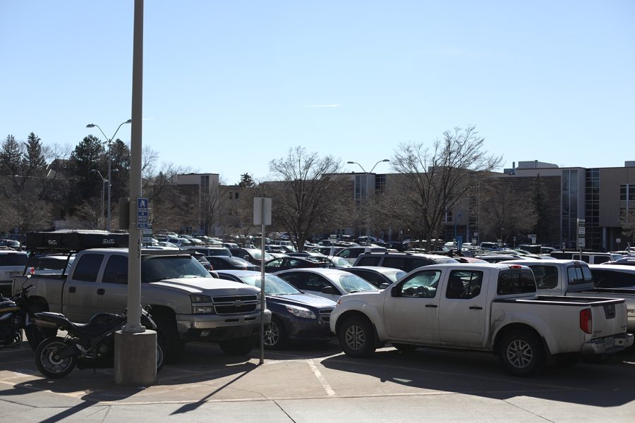 Cars fill a parking lot on a sunny day.