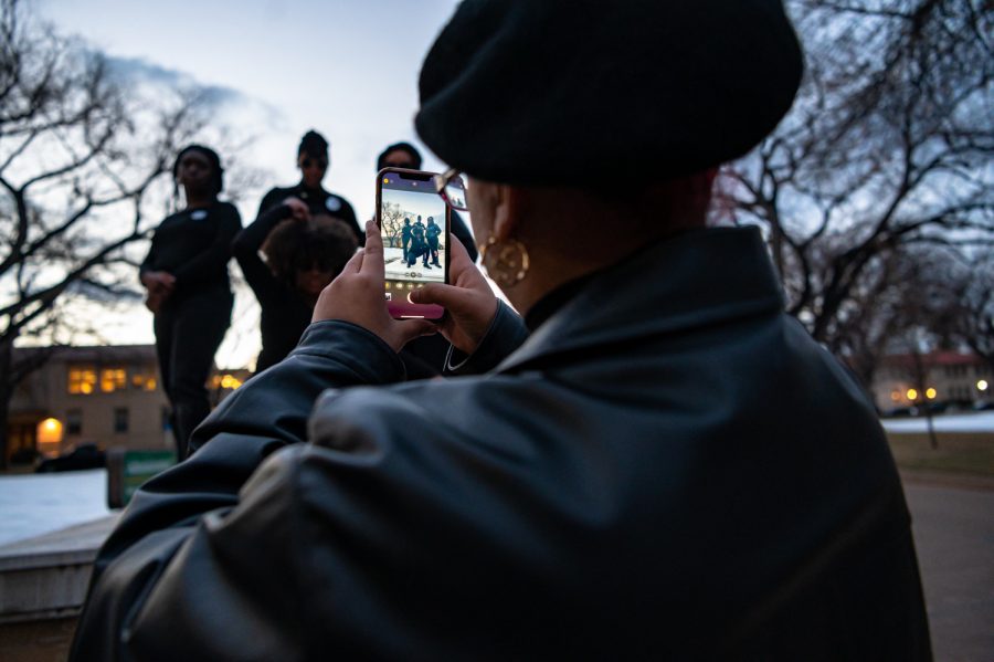 Kiah Nickels takes a photo of Colorado State University Students honor the Black Panther Party by participating Black Out event