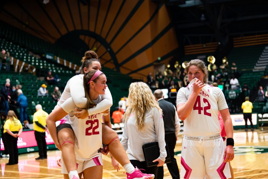 Makayla Hemingway (32), Cali Clark (22) and Karly Murphy (42) celebrate together after the Colorado State basketball game vs University of Wyoming