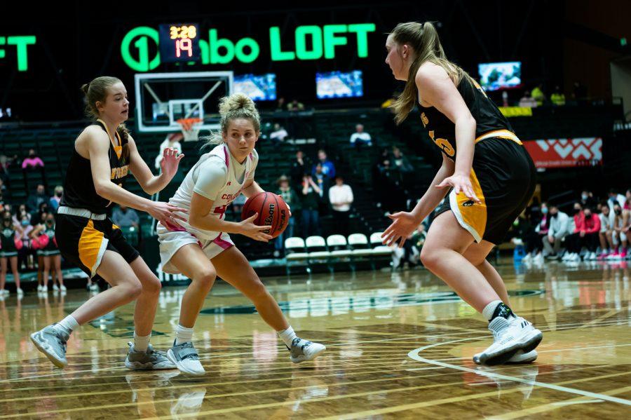 McKenna Hofschild (4) drives to the basket during the Colorado State basketball game vs University of Wyoming
