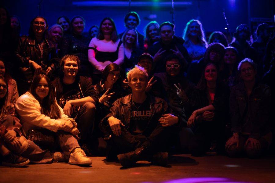 Morgan Parriott known by the artist’s name, Call Me Karizma, sits surrounded by VIP fans on the floor of The Coast in Fort Collins Colorado Feb. 19.