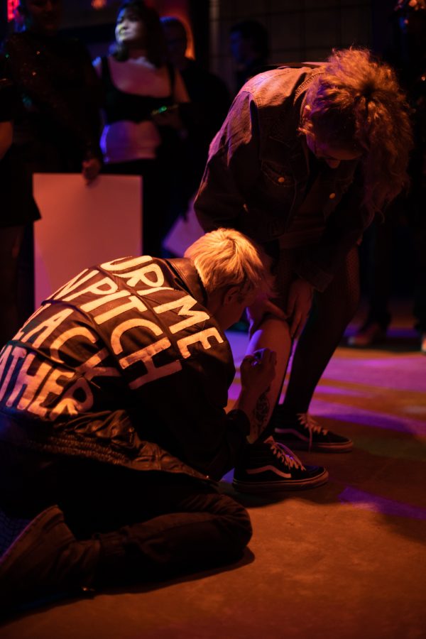 Morgan Parriott known by the artist’s name, Call Me Karizma, signs a VIP fans leg after tearing their fish net leggings at The Coast in Fort Collins Colorado Feb. 19.