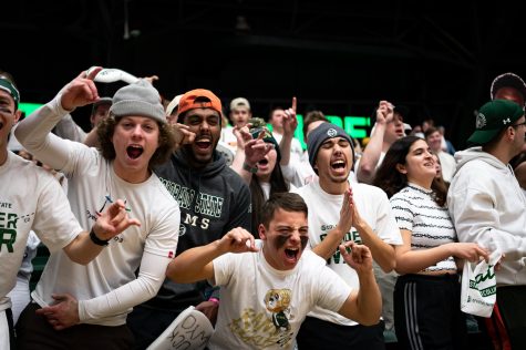 Colorado State University fans hold up their hands and cheer during the CSU basketball game vs University of Wyoming at Moby Arena