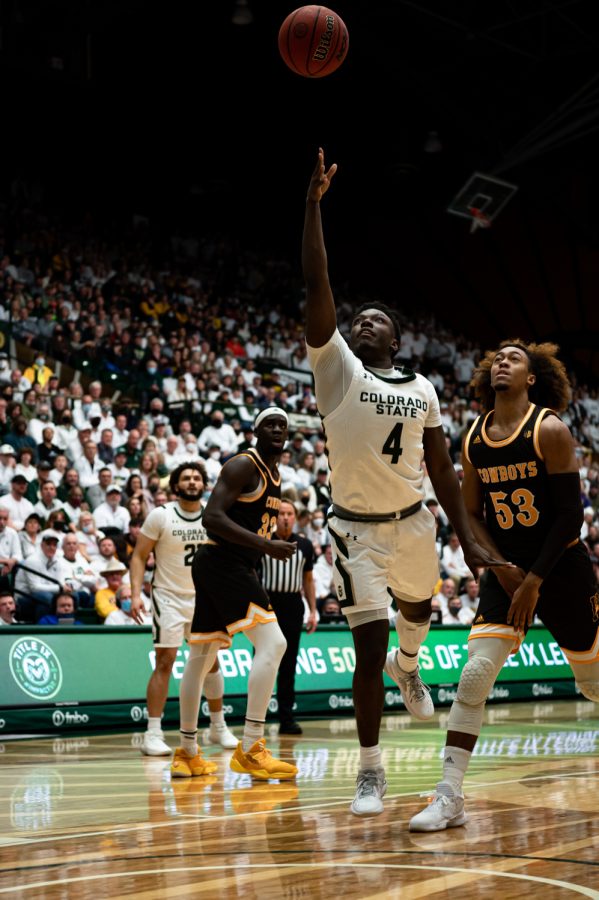 Isaiah Stevens (4) reaches for the ball during the CSU basketball game vs University of Wyoming at Moby Arena