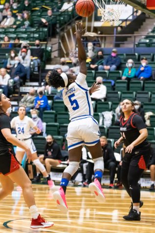 Colorado State Guard Upe Atosu (5) drives under the basket and shoots a layup.