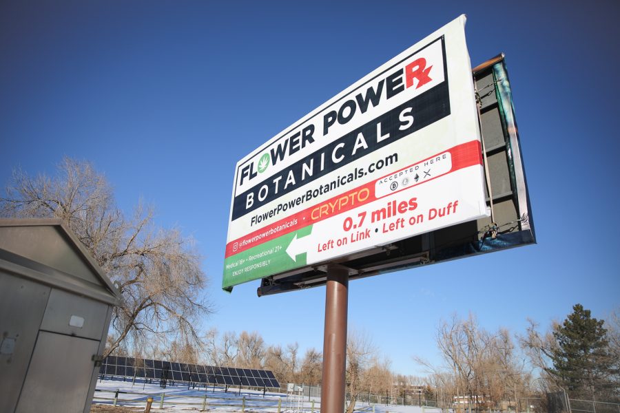 A billboard stands advertising Flower Power Botanicals Feb. 6.