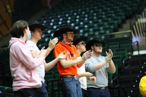 CSU fans branded The Outlaws of Moby cheer on the womens basketball team.