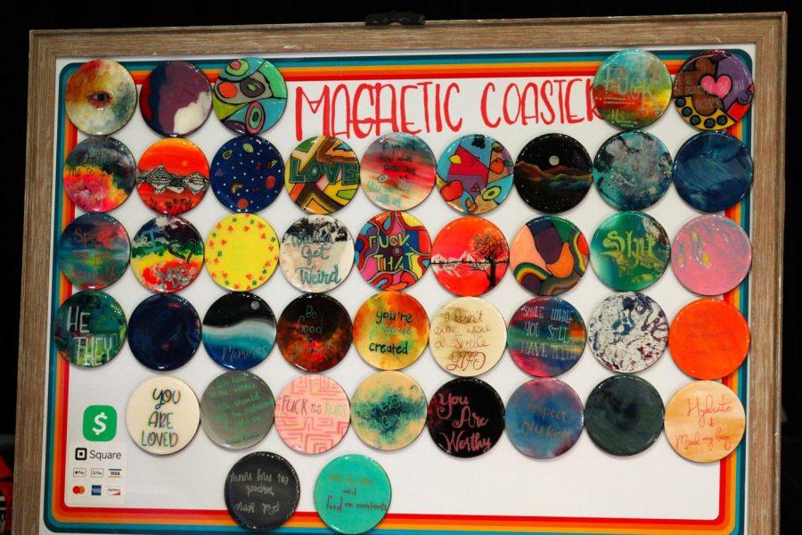 Magnetic coasters hang from a vendors board.