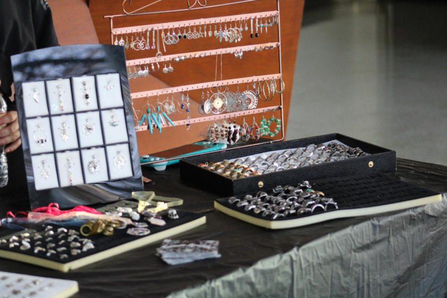 Jewelry sits on a vendor's table.