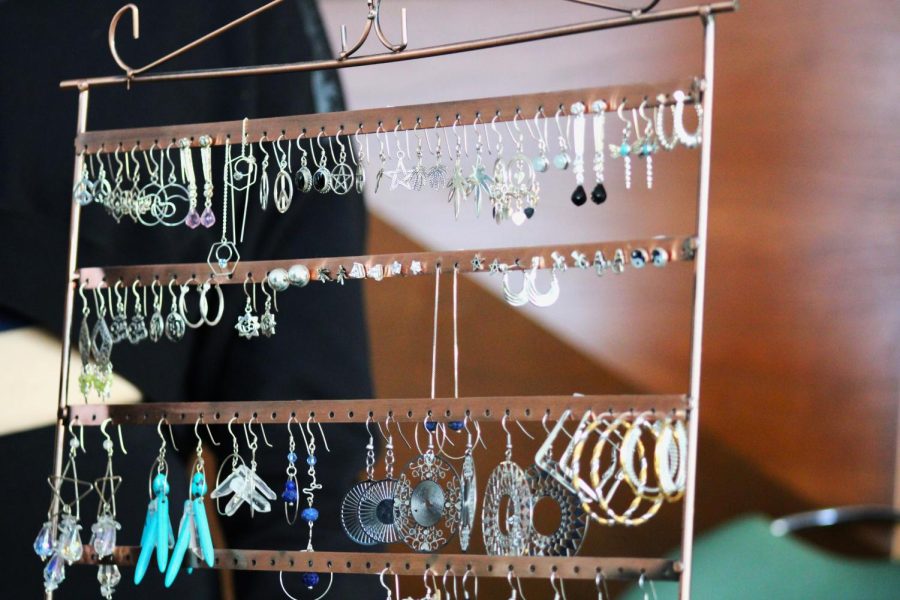 Earrings hang from a rack.