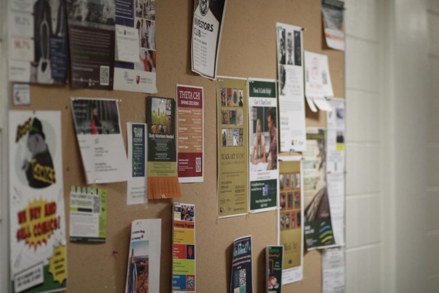 Flyers hang from a bulletin board inside of the Clark C building.
