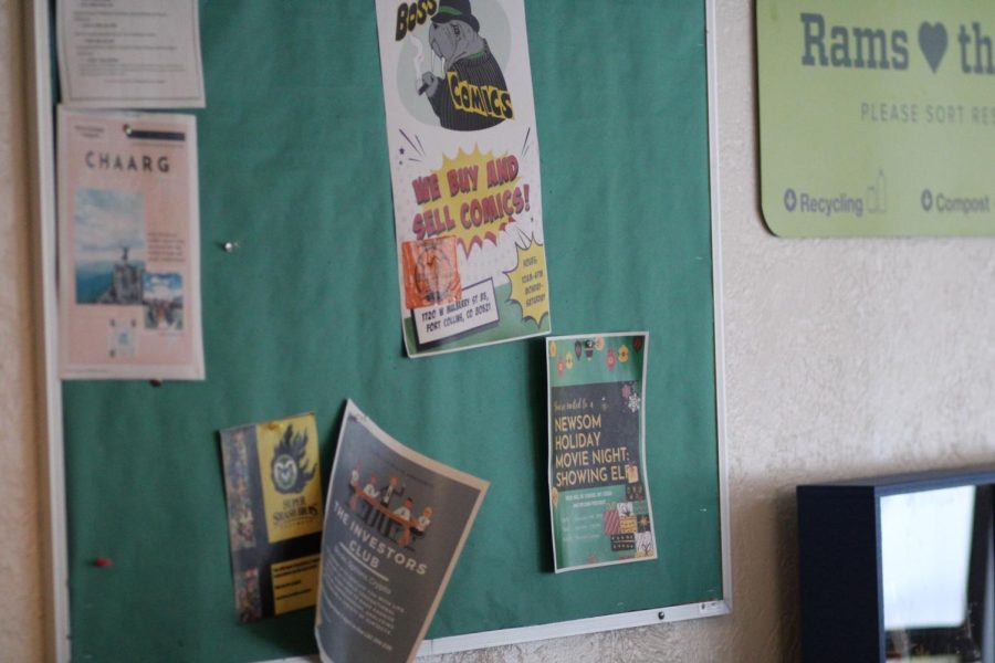 Various flyers sit pinned on a bulletin board inside Newsom Hall.