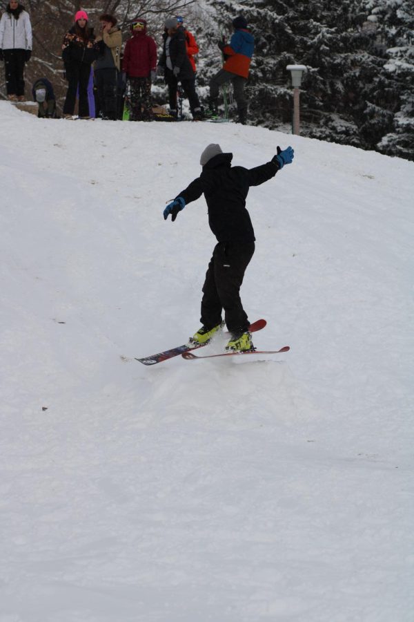 CSU students ski and snowboard down a snowy hill near the rec center.