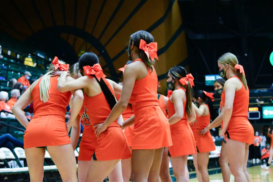Colorado State University Cheerleaders preparing to fly high at Moby Arena during the orange out game.